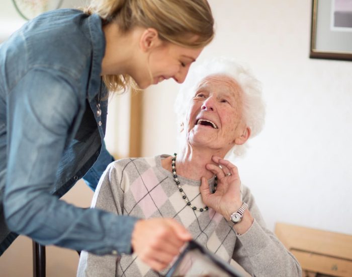 Heritage Haven Homes_About Page_Young Lady Helping Elderly Lady Heritage Haven Homes_About Page_Young Lady Helping Elderly Lady